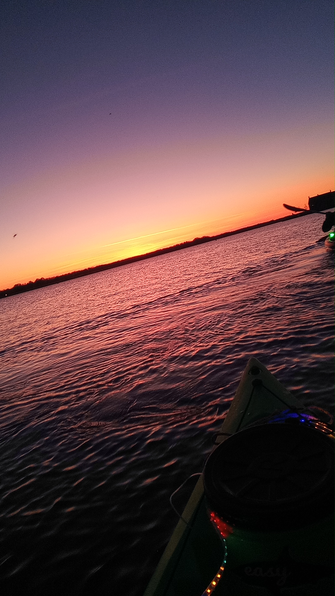 Verlichte kayak bij zonsondergang op het Oldambtmeer